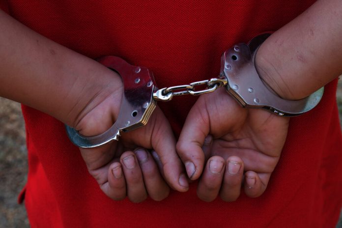 boy hands in handcuffs. no freedom
