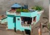 Family survives as powerful Nepal floodwaters destroy surrounding structures nearby.