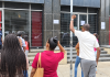 People unable to cash government cheques gather outside Treasury Building