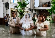 Bride and Groom Marry at Flooded Church Despite Rising Dangers