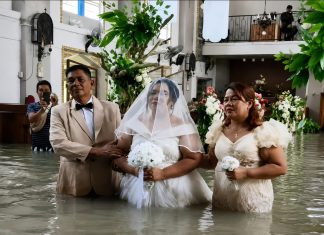 Bride and Groom Marry at Flooded Church Despite Rising Dangers