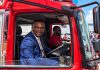 Alexander joins veteran firefighter inside refurbished appliance during reopening ceremony.