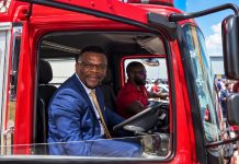 Alexander joins veteran firefighter inside refurbished appliance during reopening ceremony.