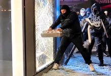 Viral footage shows cracked shopfront glass resisting repeated attempted break-ins.