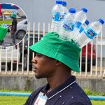 Piarco Water Vendor Gets Attention With Creative Bottle Hat